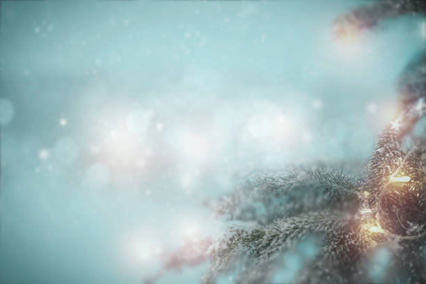 Christmas decorations on a flat winter background. Space for advertising products, decorations and text. Spruce twigs and small baubles and lights.