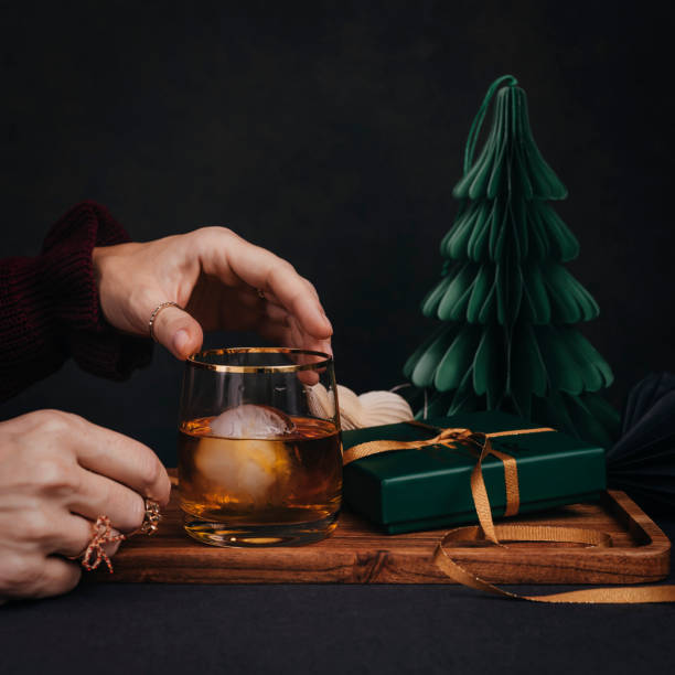 istock Woman drinking drink brandy whiskey or rum on ice Christmas feeling 1186284970