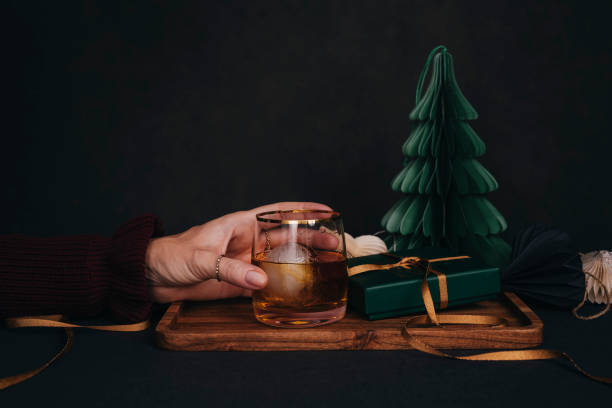 istock Woman drinking drink brandy whiskey or rum on ice Christmas feeling 1186285869