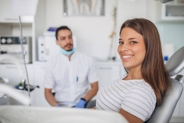 istock Dentist patient showing perfect smile after treatment 1186287987
