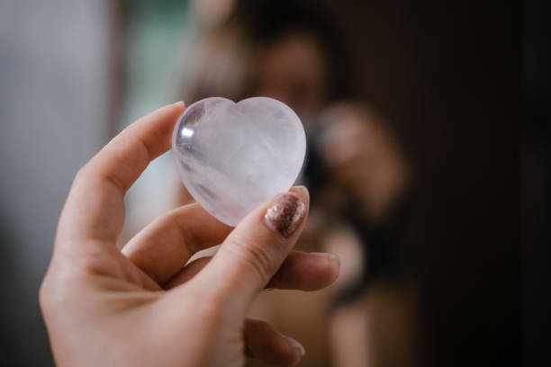 istock Woman holds rose quartz heart crystal 1186288020