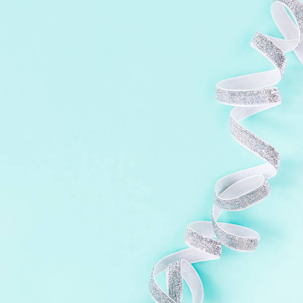 istock Glitter ribbon on pastel colored background 1186289110