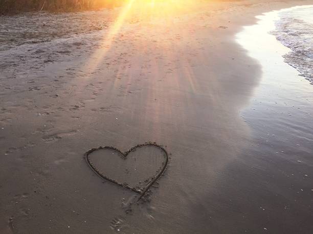 istock Painted heart on sand. Vacation on sea 1186289767