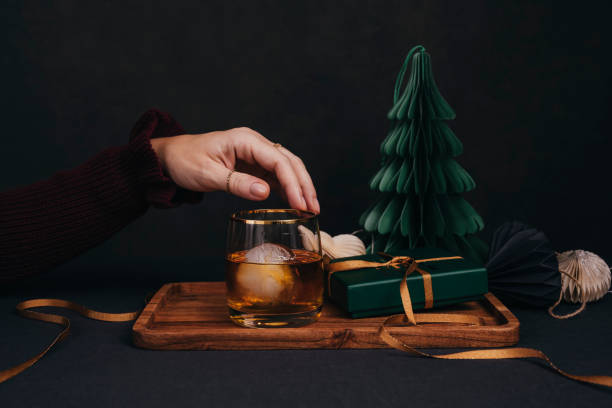 istock Woman drinking drink brandy whiskey or rum on ice Christmas feeling 1186290967