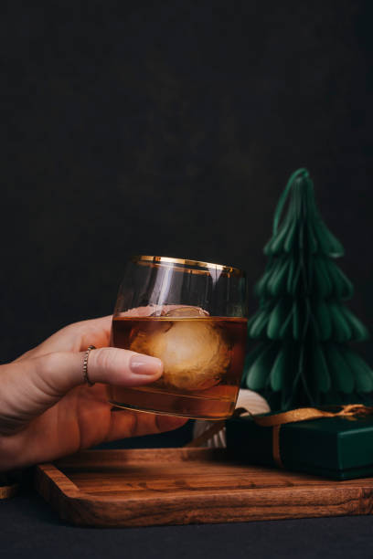 istock Woman drinking drink brandy whiskey or rum on ice Christmas feeling 1186291212