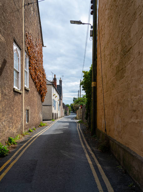 istock A small country lane running between houses 1186291269