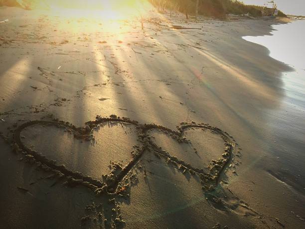 istock Painted heart on sand. Vacation on sea 1186291278