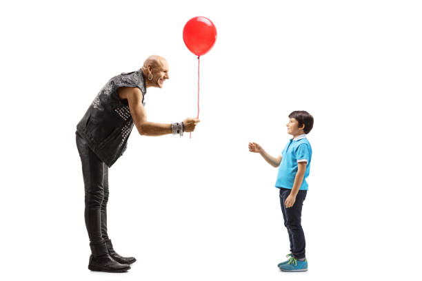 istock Punker in leather clothes giving a red baloon to a child 1186291390