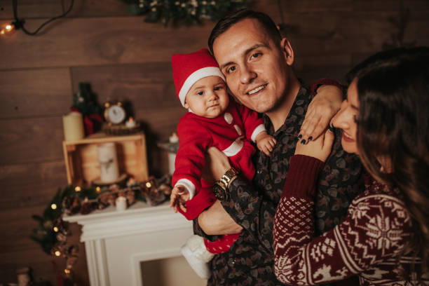 Young happy family celebrating Christmas and New Year holidays  at home