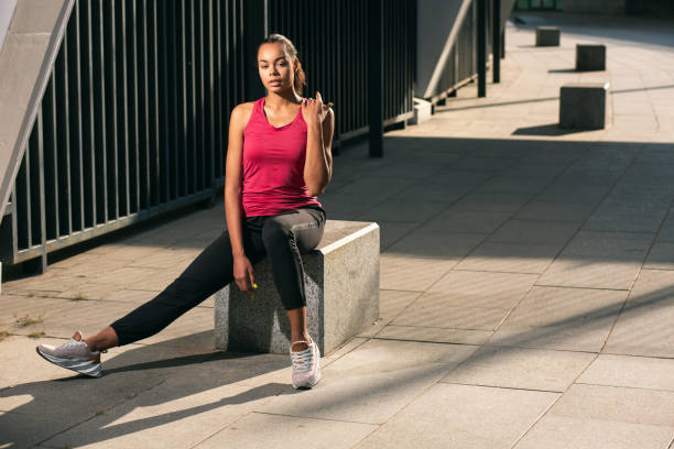 istock Calm thoughtful lady sitting on granite cube stock photo 1186297533