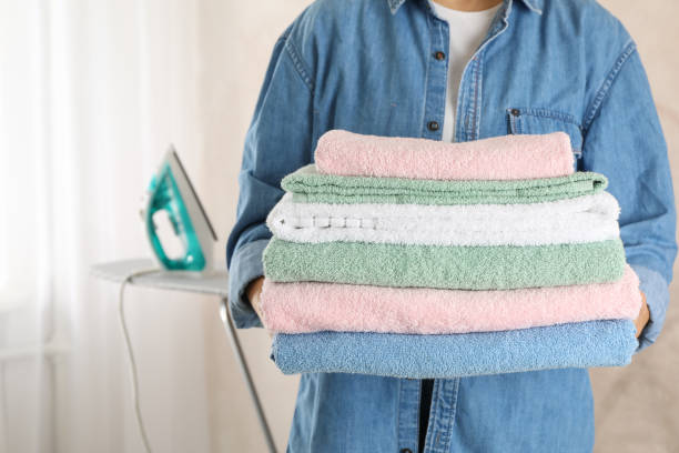 istock Young woman hold clean towels, close up and space for text 1186299973