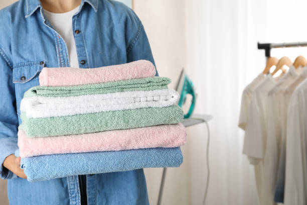 istock Young woman hold clean towels, close up and space for text 1186300084