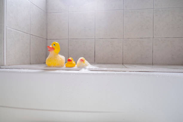 yellow ducks in foam, baby bathing toys - bath toy imagens e fotografias de stock