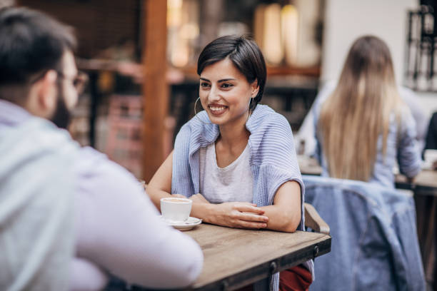 istock Man and woman sitting in sidewalk cafe 1186301390
