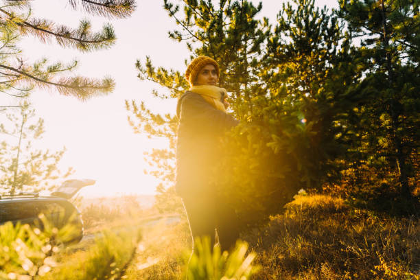 Young woman carrying home her Christmas tree
