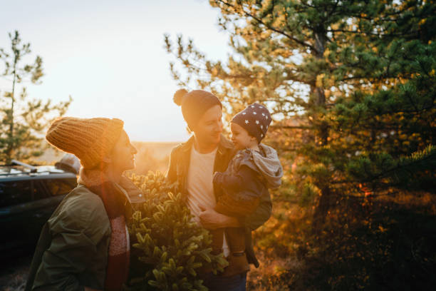 istock Young family on a Christmas tree farm 1186301582