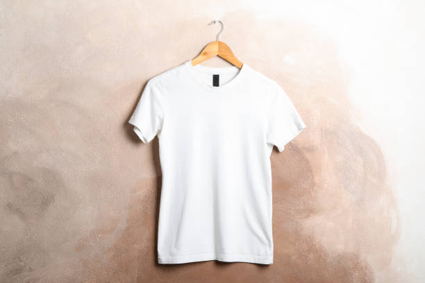 istock Hanger with blank white t-shirt on brown background, space for text 1186301596