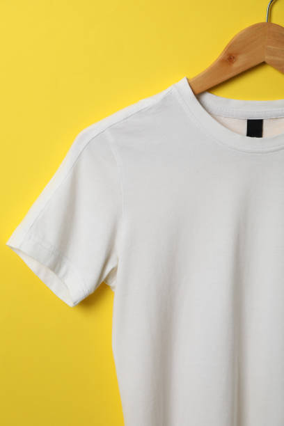 istock Hanger with blank white t-shirt on yellow background, space for text 1186301685