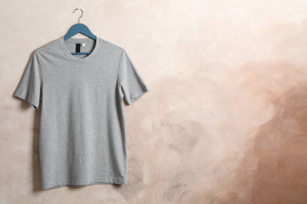 istock Hanger with blank gray t-shirt on brown background, space for text 1186302026
