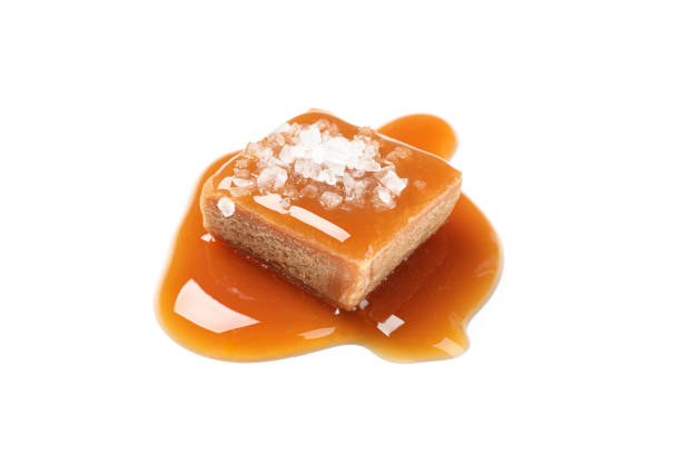 istock Salted caramel candy with sauce isolated on white background 1186303199