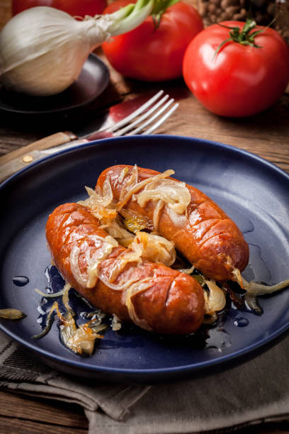 istock Fried sausage with onions. 1186303244