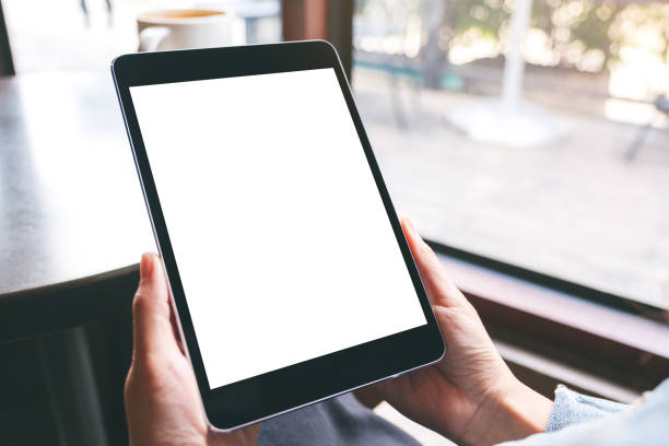 istock a woman holding black tablet with white blank screen and coffee cup on the table 1186315996