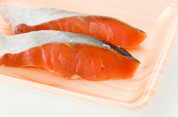 istock Coho Salmon fillet in foam tray on white background 1186317408