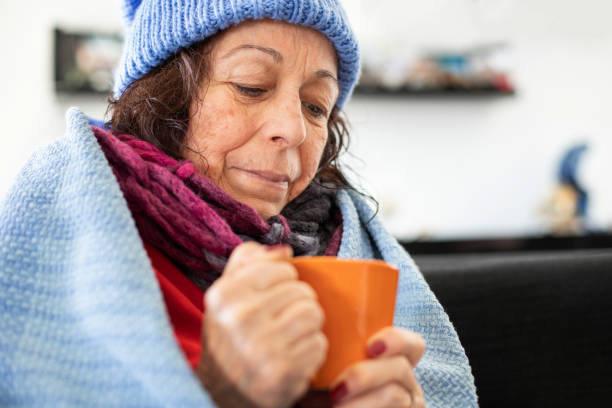 istock Elderly woman checking her temperature when she is flu and cold 1186318892