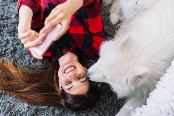 istock Young woman at home taking selfie with her dog 1186320650