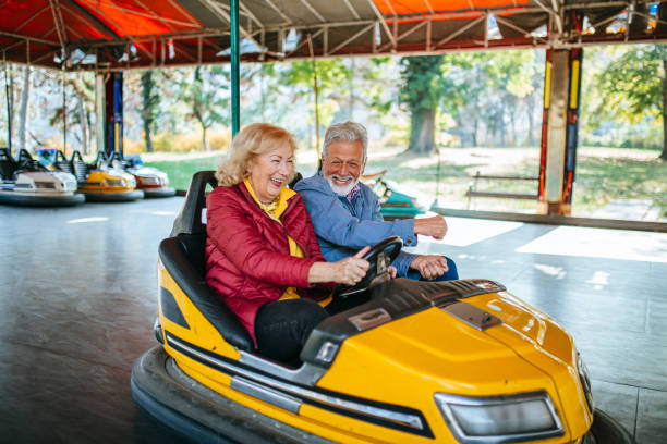 istock Amusement park - senior couple in bumper car 1186320807