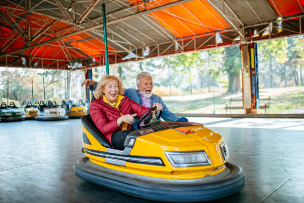 istock Amusement park - senior couple in bumper car 1186320810