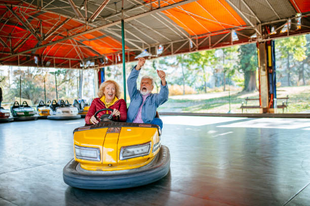 istock Amusement park - senior couple in bumper car 1186320864