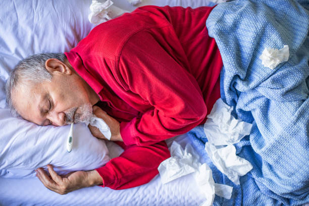 istock A senior flu man is lying on the bed with fever 1186320904