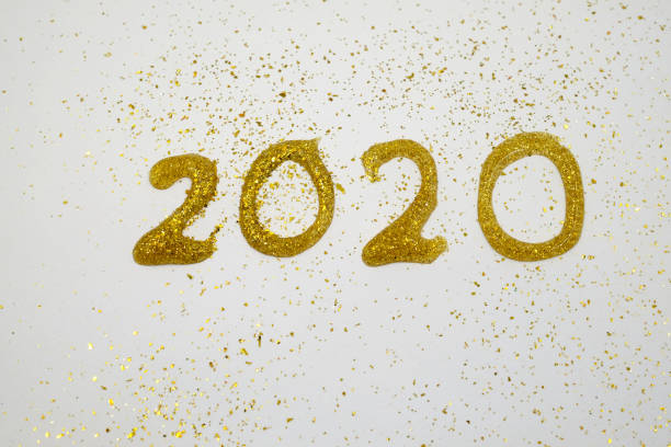 istock text of 2020 write by glitter pen on white paper 1186323491