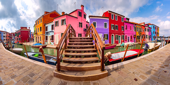 Panoramic view of Canal with colorful houses and bridge on the famous venetian island Burano, Venice, Italy