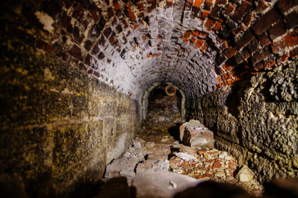 istock Old collapsed red brick underground vaulted historical sewer tunnel, selective focus 1186325034
