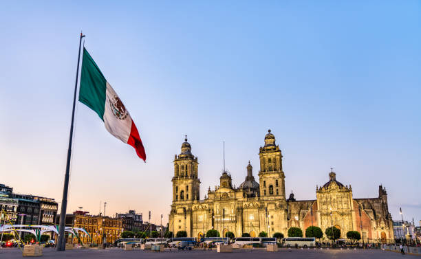 Flagpole and the Metropolitan Cathedral of the Assumption of Virgin Mary in Mexico City, the capital of Mexico