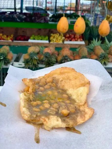 A very popular street food native to Trinidad, doubles consists of two fried dough rounds with a savoury chickpea filling. Typical garnishes include a variety of chutneys and hot sauce.