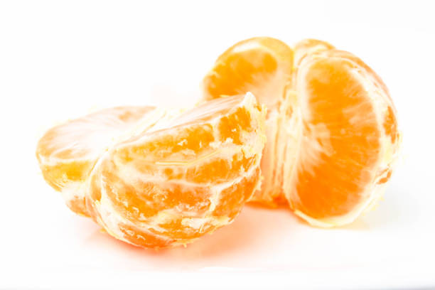 istock Half tangerine orange cut in half on a white background 1186326817