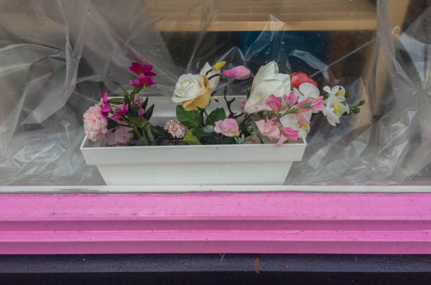 Pink window decoration withe and pink plastic flowers in plastic