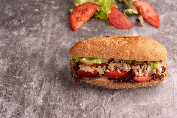 istock Sandwich Tuna with filling from lettuce, tomato with whole wheat bread. 1186328652