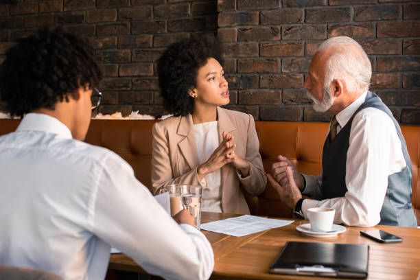 istock Three multi cultural business people having meeting at cafe. 1186329447