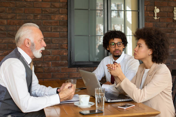 istock Two representatives of a company meeting with a client. 1186330066