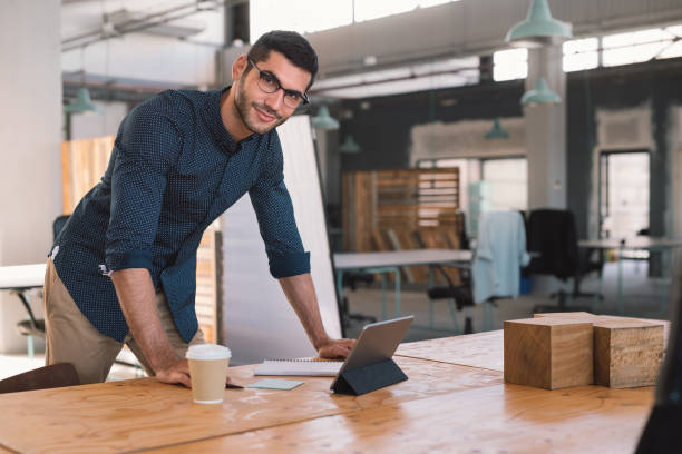 istock Smiling businessman working over his desk in an office 1186330849