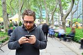 Caucasian Man in 30s Texting in Union Square Park NYC on a Spring Day