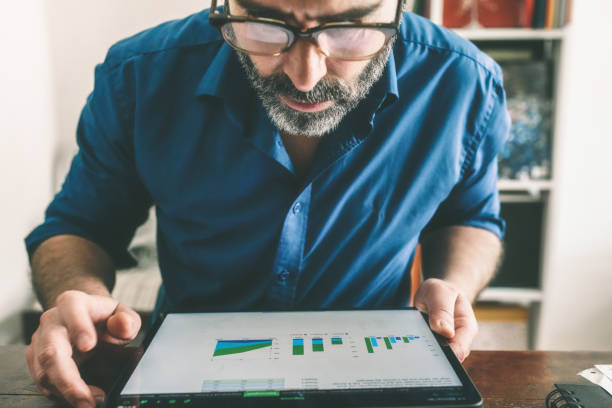 istock man checking business stats at digital tablet 1186334498
