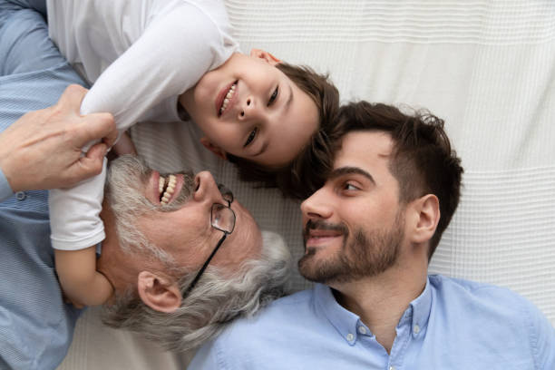 istock Affectionate multi three generation men family top view closeup portrait 1186336110