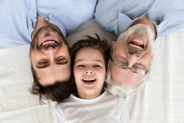 istock Happy three generation family lying in row, portrait, closeup view 1186336111
