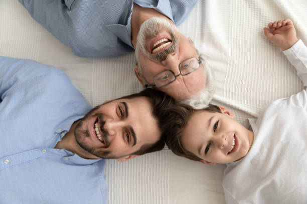 istock Three generation men family lying in circle, portrait, top view 1186336112