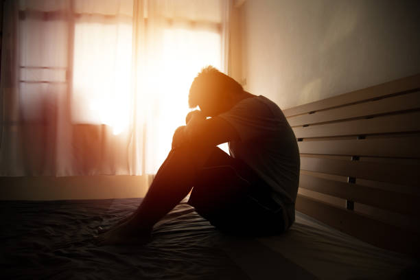 istock Depressed Man Sitting On Bed At Home 1186340447